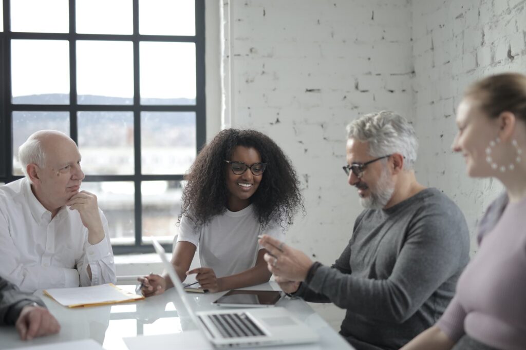positive-colleagues-discussing-project-in-office